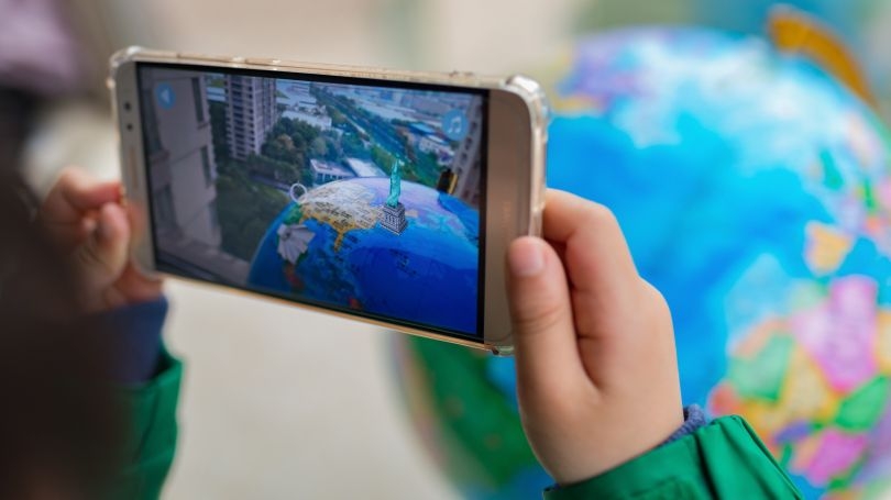 Child holding a mobile device