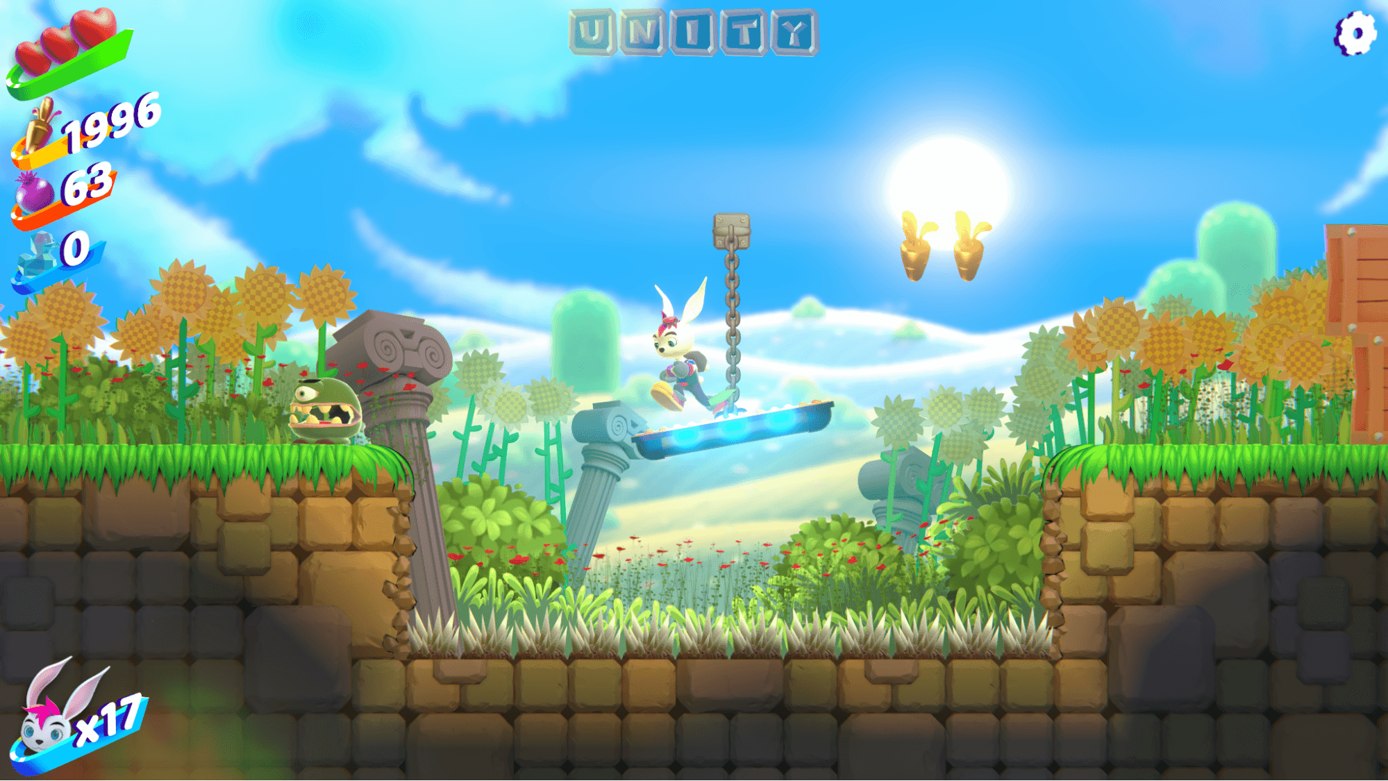 「バニーブリッツ」のゲームプレイスクリーンショット 明るい草地レベルの水上プラットフォームに、ピンク色の毛をしたウサギのキャラクターが、ひまわり、古代の石の柱、金のニンジンのコレクティブルでジャンプしているところ。HUDには心拍計、アイテムカウント(1996、63、0 ) 、 上部に「Unity」の文字、左下に「x17」のウサギが生息しています。