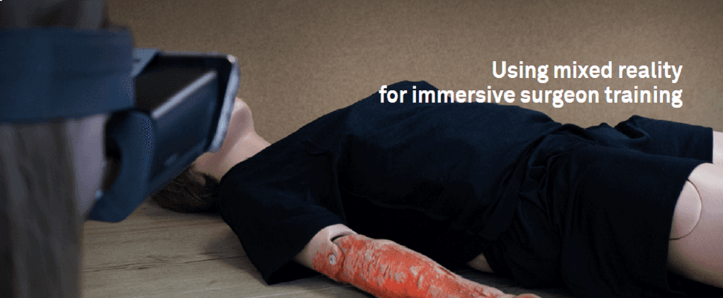 Project Ember banner showing a person in a VR headset viewing a medical mannequin with a simulated arm burn for immersive surgeon training.