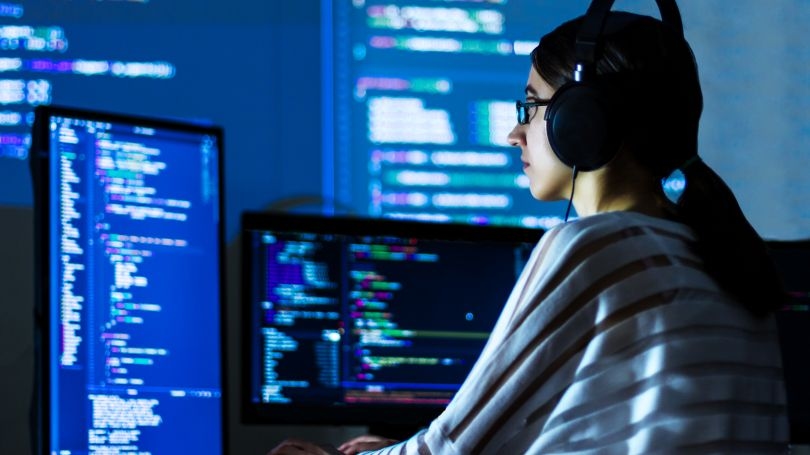 Woman using computer to code