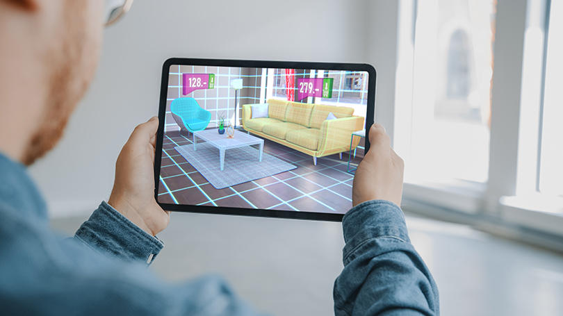 Man holding tablet viewing home decor in real-time 3d